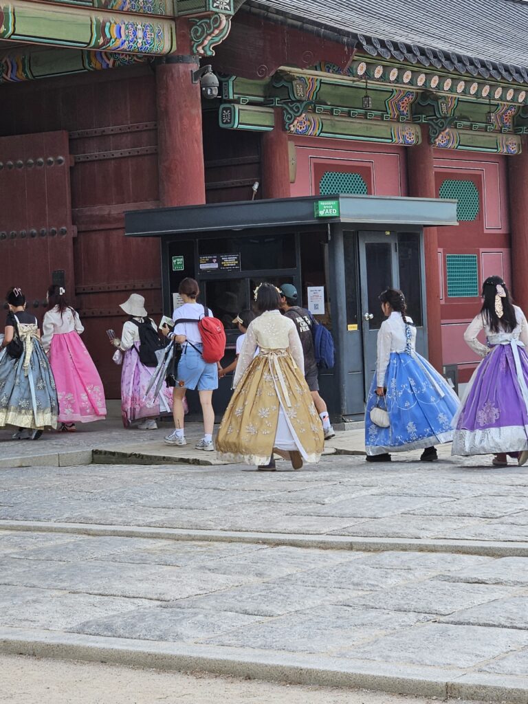 Visitors entering Seoul palace in traditional costume.